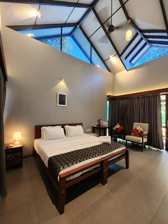 Cottage bedroom with skylight, double bed and reading chair